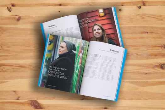 Two Deconstructing Stigma books open and stacked on top of one another on a wooden background