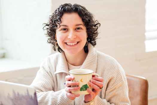 Participant Marena - person smiling with a mug