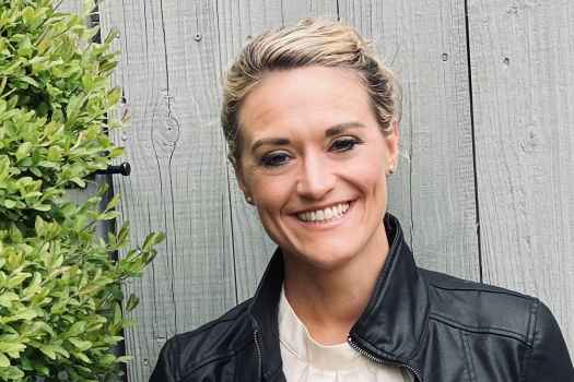 Participant Mandy - person with blond hair pulled back into an updo wearing a black leather jacket