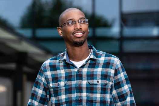 Participant Charles - person with very short hair and glasses walking outside
