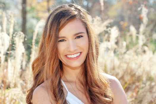 Participant Cali - person with long wavy hair smiling