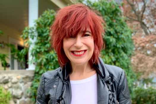 Participant Jen - person with red hair smiling outside