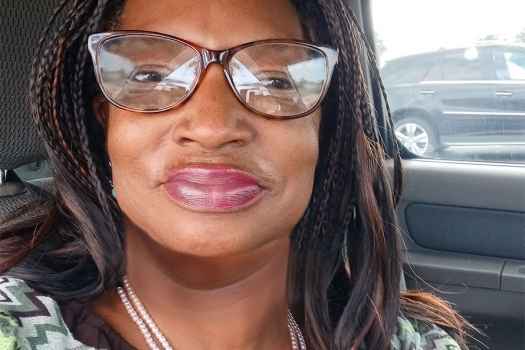 Participant Sylvia sitting in a car wearing glasses
