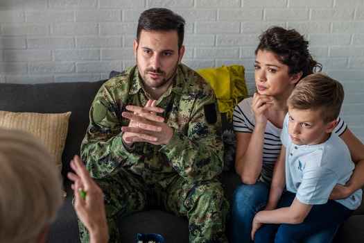 Military family on couch talks to therapist