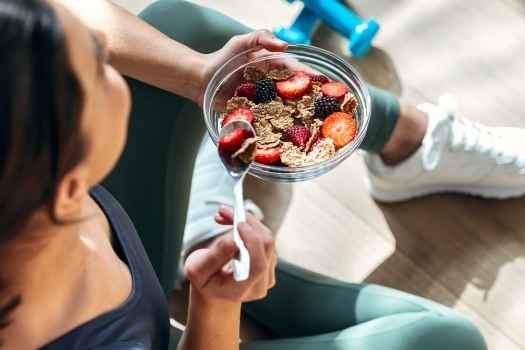 Person eating bowl of healthy cereal