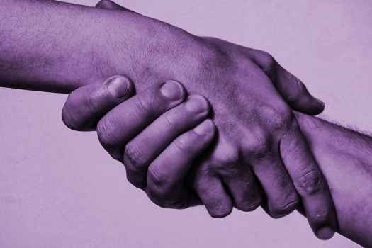 Grasping hands purple overlay