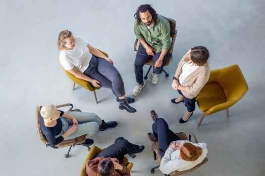Aerial view of a group of people sitting in chairs in a circle