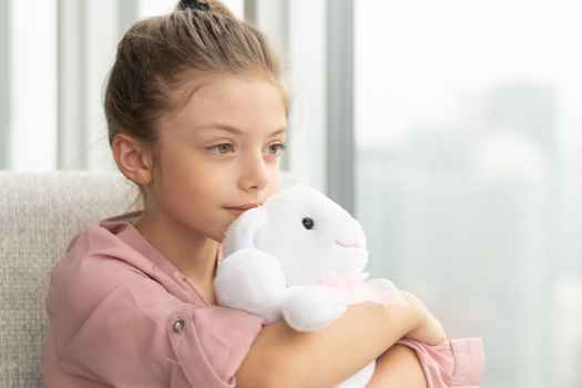 Young girl holding a stuffed toy