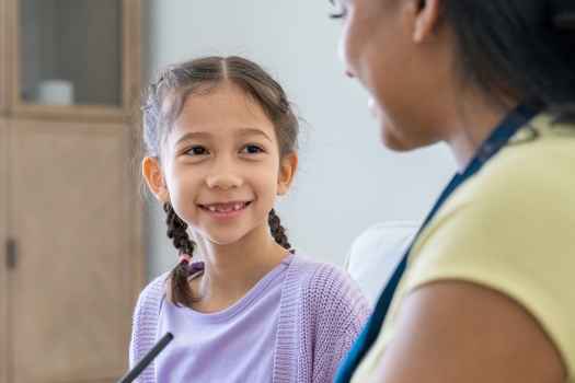 Clinician and young girl talking