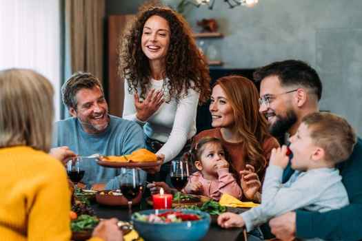 Group of people smiling around a table with food