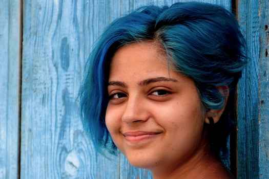 Girl with blue hair looking at camera
