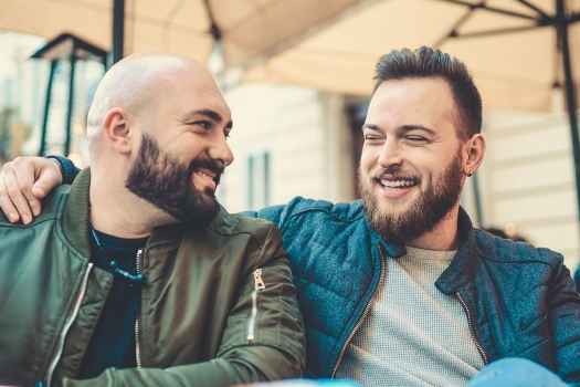 Two men hanging out on a porch