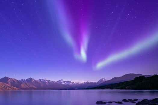 Purple night sky over mountain and lake