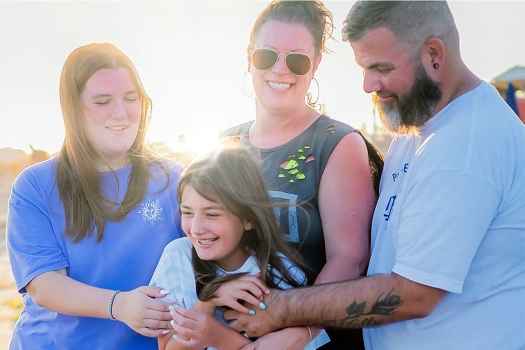 Deconstructing Stigma participant Tom with family outside