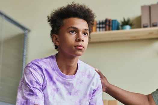 Youth looks out with adult