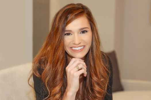 Participant Cali - person with long wavy hair smiling