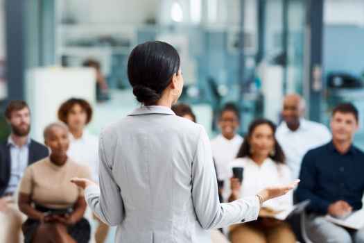 Lecturer stands in front of learners
