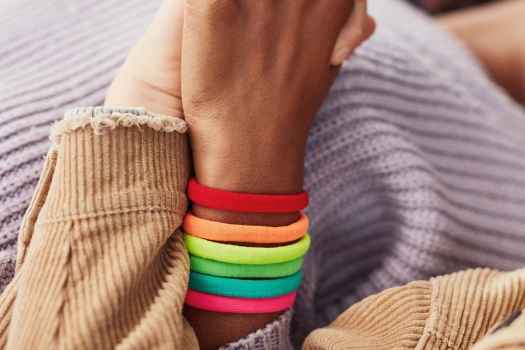 Hands holding with colorful bracelet