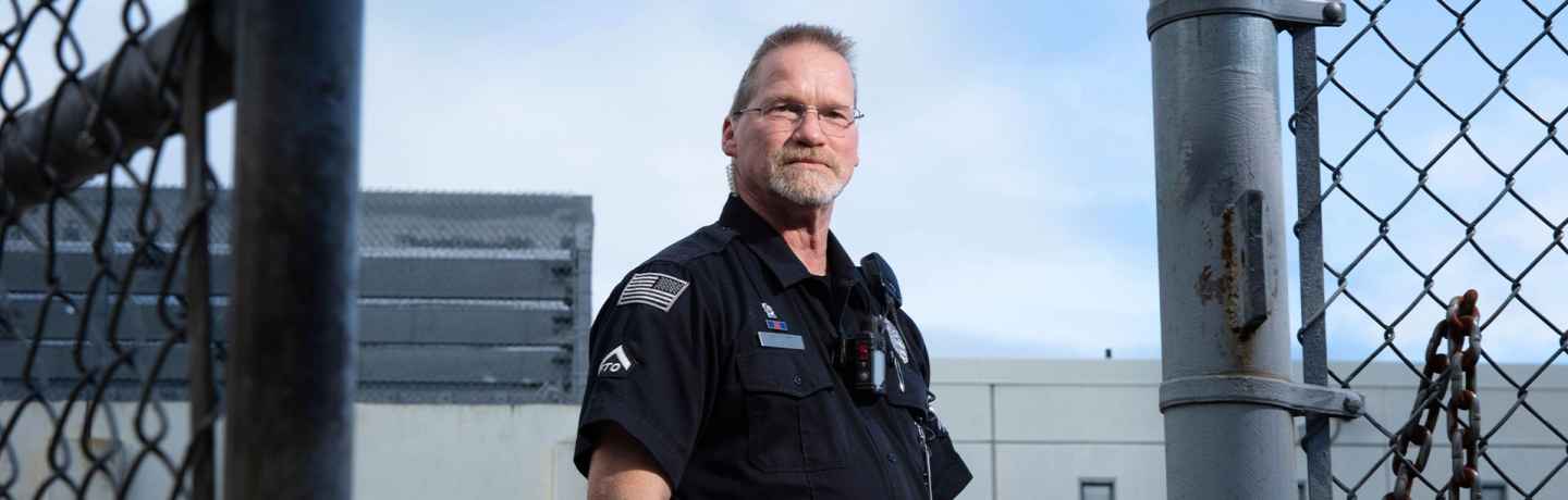 Participant Kevin - person in police uniform in the opening of a gate