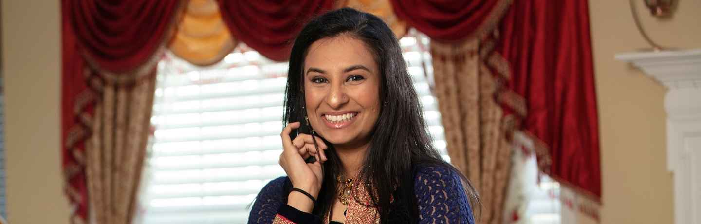 Participant Vaidehi - person with long dark hair in front of a window with curtains