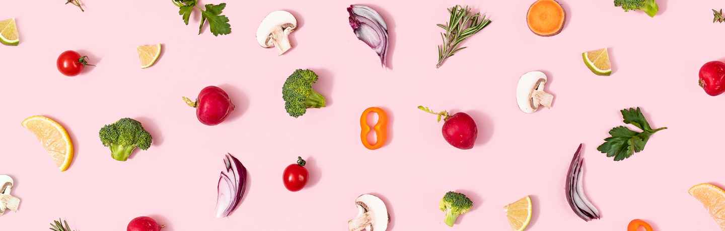 Pattern of fruits and vegetables on a pink background