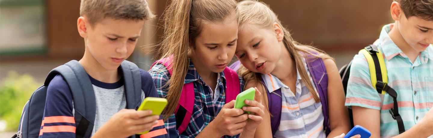 Kids at school looking at phones