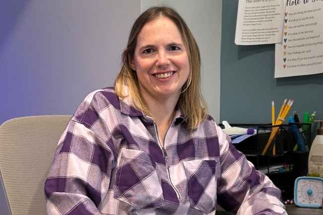 Participant Julie - person in purple shirt sitting at a desk