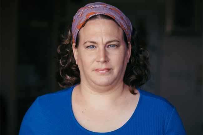 Deconstructing Stigma participant Judith - portrait of person with kerchief in hair, blue shirt
