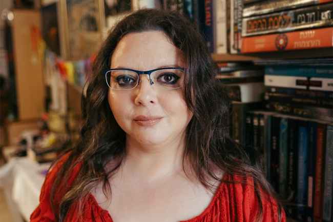Deconstructing Stigma participant Shlomit-Coana - person in red dress and glasses