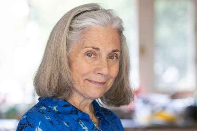 Participant Cynthia - person with grey hair wearing a blue shirt and smiling