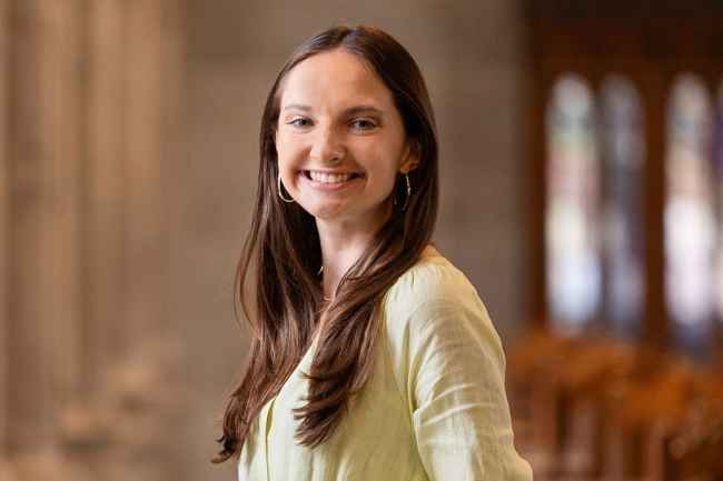 Deconstructing Stigma participant Rebecca - person stands by columns