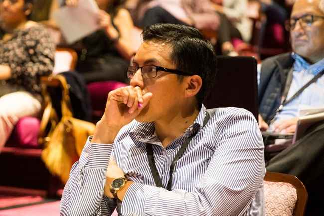 Adults sit in auditorium learning