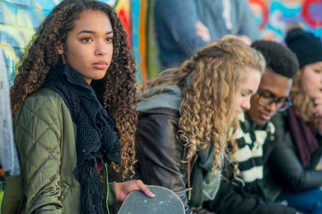 Teens sit outside in cool weather