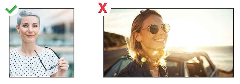 People with glasses, one is wearing sunglasses and one is holding glasses