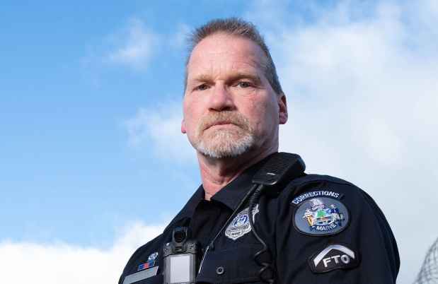 Participant Kevin - person in police uniform in front of a blue sky with clouds