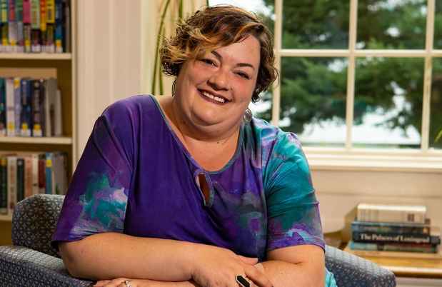 Participant Laura - person with short brown hair and a purple and teal shirt