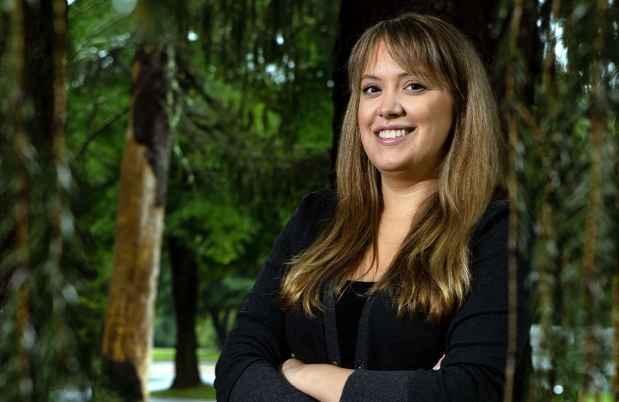 Participant Kimberly - person in a sweater among trees