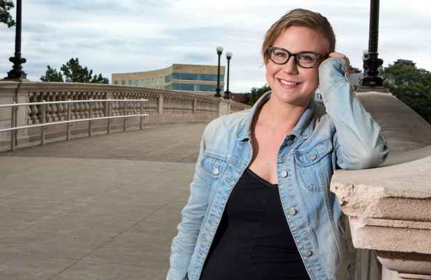 Participant Kelsey - person in glasses wearing a denim jacket and smiling