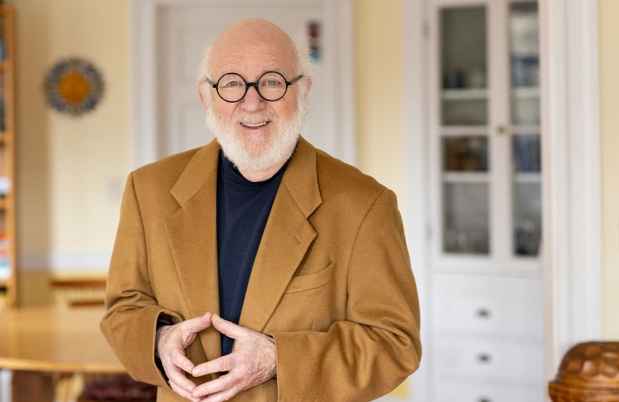 Participant Larry - person with short white hair in a brown jacket