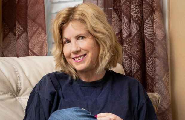 Participant Lisa - person with short blond hair sitting in a chair