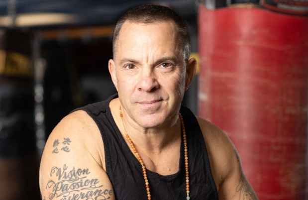 Participant Kevin - person in black tank top surrounded by exercise equipment