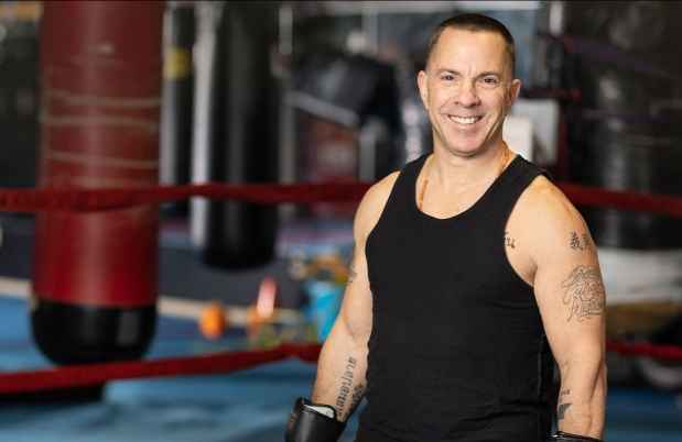 Participant Kevin - person smiling surrounded by exercise equipment
