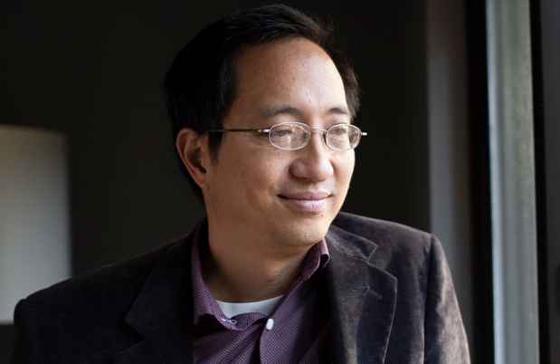 Participant Leonard - person with short hair and glasses smiling softly and looking out a window
