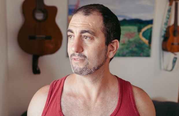 Deconstructing Stigma participant Leor - portrait of person in red tank top
