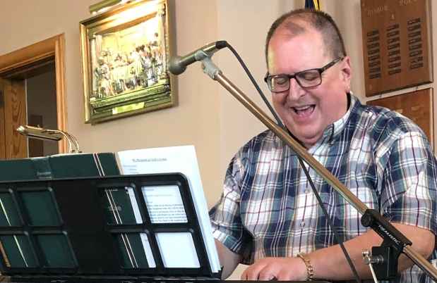 Participant Thomas - person smiling playing a keyboard