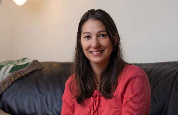 Participant Maria - person with dark hair and a bright coral shirt