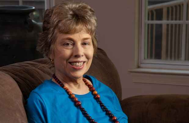 Participant Meredith - person with short blond hair wearing a teal shirt and a long necklace