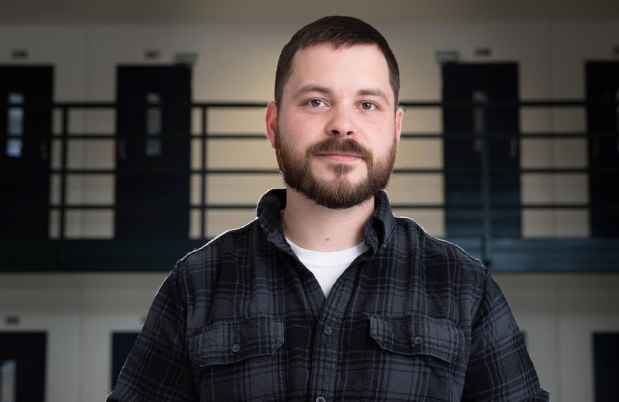 Participant Ron - person in plaid shirt in front of doors