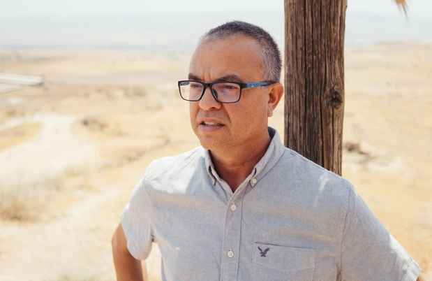 Deconstructing Stigma participant Shay - Person stands outside on desert sand