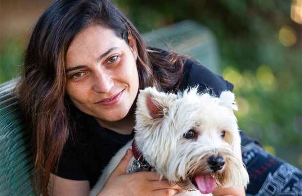 Participant Shelly - person with long dark hair with a small white dog